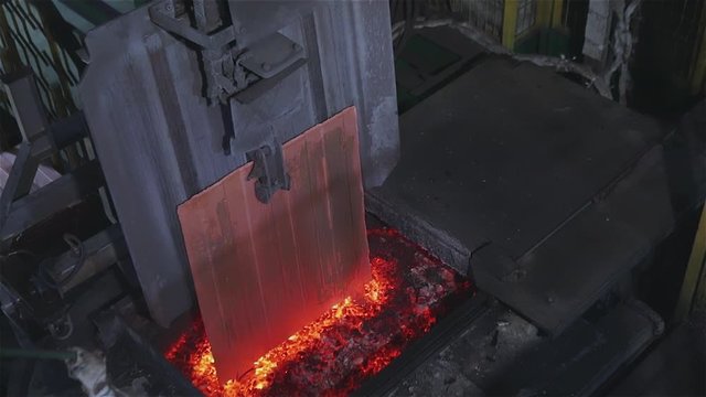Automated copper feed line to the furnace. The melting of copper in the furnace, the process of melting copper in the furnace.