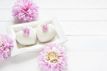 Fototapeta na wymiar Heart mousse cakes covered with white chocolate velvet decorated of pink flowers