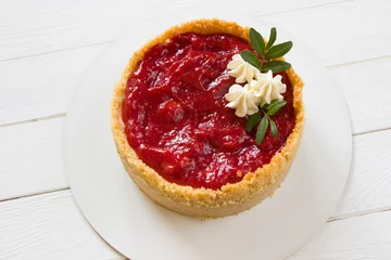 Foto op Plexiglas Cheesecake  with strawberry sauce .Homemade fresh  dessert. White wooden board © Grandiflora
