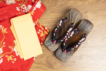 Japanese traditional geta sandal and traditional clothes of Kimono, Yukata on wooden floor.