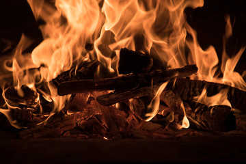 Fototapeta premium Fire and burn coals in stone oven. Oven made of brick and clay on the wood. Oven for pizza.