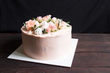 Delicate wedding cake decorated with beautiful pink and white fresh roses