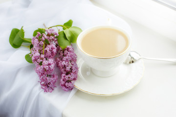 postcard good morning. a Cup of coffee , a branch of lilac on the window