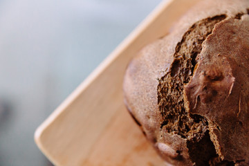 Fresh homemade crisp brown bread. Freshly baked bread on wooden cutting board. 