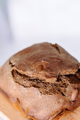 Fresh homemade crisp brown bread. Freshly baked bread on wooden cutting board. 