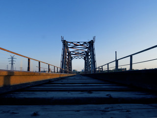 Fototapeta premium Old railway bridge at dawn. Photo in blue tones.