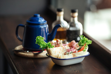 Pita bread with smoked fish greens and vegetables