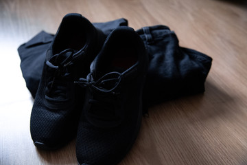 Black sneakers and black clothing.