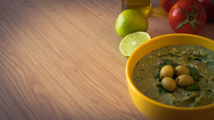 guacamole typical mexican food on wooden table
