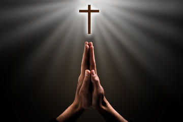 Hands clasped. Close-up of hands clasped isolated on black