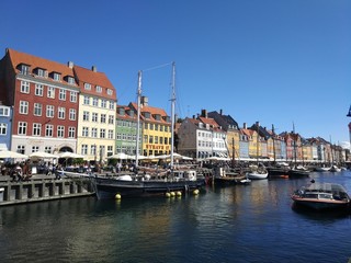 Copenhagen, Denmark. August 23, 2017: Traditional Nyhavn houses in Copenhagen, Denmark. Along the canal there are many colored townhouses of the 17-18 centuries, bars, cafes and restaurants.