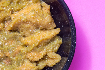 Pork rinds in green salsa with refried beans