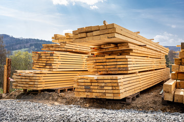 Stack of wooden beams on construction site prepared for building a house