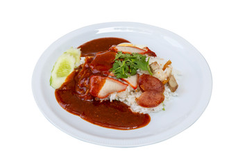 Red pork over rice topped with red sauce with 2 slices of cucumber on a white plate on a white background with clipping path.