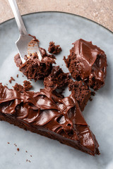 One piece, serving brownie chocolate pie on a blue plate, macro, close up.