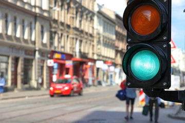 Traffic light green. Street blurred background.  Blurred background - Powered by Adobe