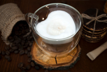 Glass cup in the shape of a heart and double glass. Cappuccino and chocolate cookies. 
