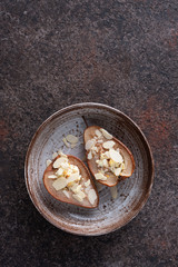 Baked pears with cottage cheese and honey decorated with almond slices. Top view.