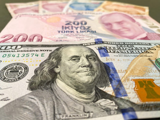 Obraz na płótnie Canvas Turkish Liras and one hundred American Dollar. Turkish lira depreciates against the US dollar