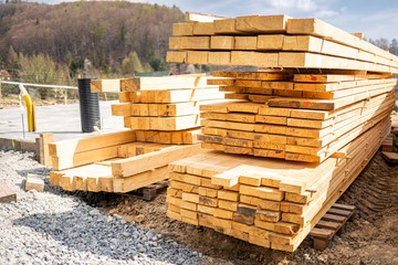 Stack of lumber wooden beams prepared to build a house
