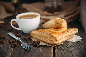 coffee and croissant on the wooden table.