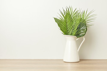 Tropical plant with green leaves on bright white background. Flat lay.