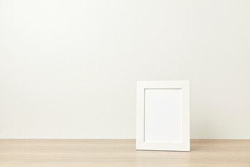 Photo frame on wood table. On white background with copy space
