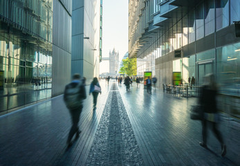 business people, modern buildings and Tower Bridge, London, UK