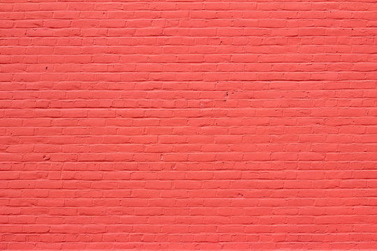 Old red painted brick wall texture background showing weathering from normal aging