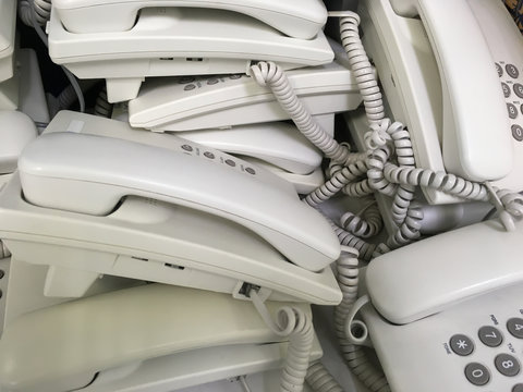 Close up of unused white telephones waiting for scrapping