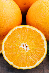 Orange slices cut in half and oranges