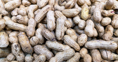 Unpeeled peanuts as background