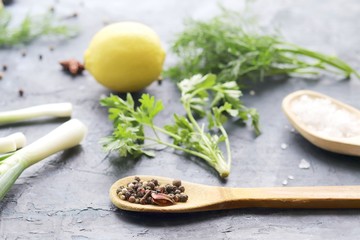 
Fresh herbs, asparagus, lemons, spices on the kitchen table for preparing healthy homemade food from organic products