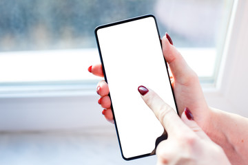 close-up view of young woman using her mobile phone with blank screen