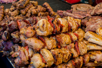 Chef preparing meat on the grill, during outdoor outside food festival