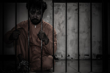 Asian man desperate at the iron prison,prisoner concept,thailand people,Hope to be free,Serious...