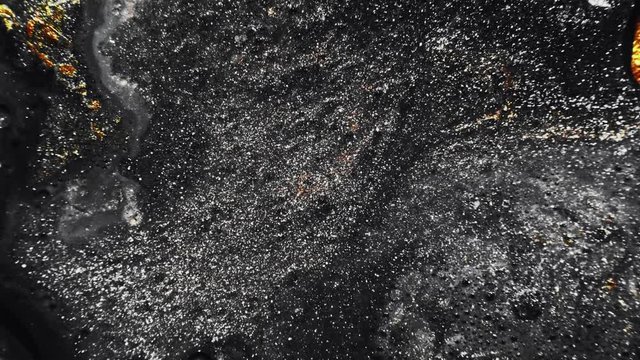 Glitter ink texture. Cosmic dust. Shimmering black golden liquid flow overlay effect.