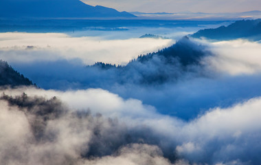 Naklejka na ściany i meble panorama of amazing foggy sunrise over mountains