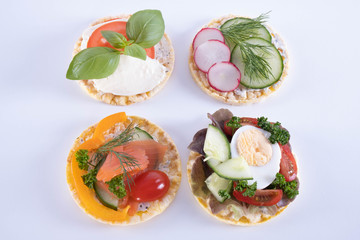 radish, salmon, tomatoes, paprika and dill on corn waffles