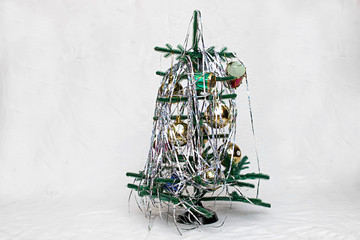On a white background Christmas tree decorated with toys. Image with selective focus and toning.