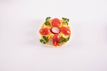 chopped tomato, radish, cheese and parsley on a corn waffle