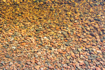 Small stones in the water of The Lake Saimaa, Kylaniemi island, Finland
