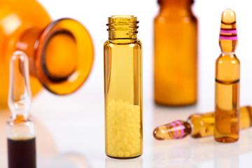 herbal and homeopathic pills in medicinal flask