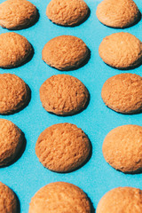 Flat lay of pattern of delicious cookies on blue background.Copy space