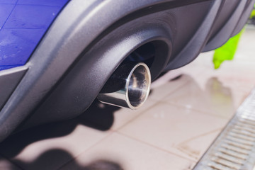 Car exhaust pipe with soap. Car wash background. close-up