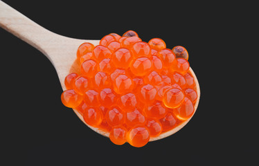 Salmon roe in wooden spoon.