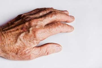 Hands of an aged mother. Wrinkles on the hands of an old grandmother. Appreciate the parents. Old hands close-up. Grandmother's hands on a white background. Care for an aging mother. Don't leave paren