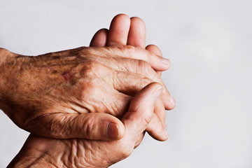 Wrinkles on old grandmother's hands on a white background. Kind, caring hands of an old grandmother. Hands with wrinkles close-up. The aged skin of an old mother. Appreciating Parents: Caring for an 