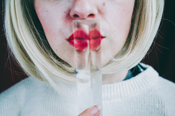 Close up of a young woman's face covering by a prism
