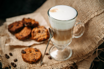 Latte Macchiato with cookies on the wooden table